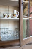 Wooden cabinet with glassware and crockery 