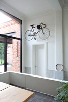 Bicycle hanging above door in hallway 