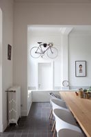 Modern dining room with view to hallway and wall mounted bicycle 