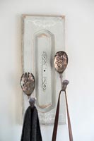 Coat hooks made from old wooden door panel and cutlery 