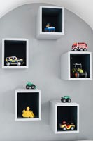 Box shelves with cars and toys displayed 
