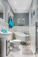White bathroom with pale grey painted walls 