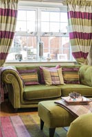 Green and pink furnishings in classic living room 