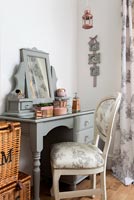 Modern bedroom with painted dressing table and vintage chair 
