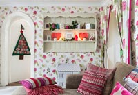 Floral wallpaper and curtains in living room at Christmas 
