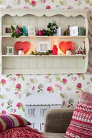 Floral wallpaper shelf unit in living room at Christmas 
