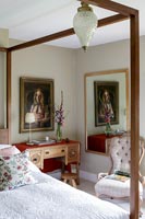 Four poster bed and desk in classic bedroom 