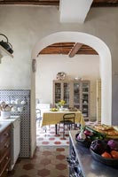 Country kitchen with archway to dining room