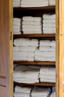 Towels neatly stored in wooden cupboard 