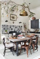 Decorated branch over dining table in modern kitchen-diner 