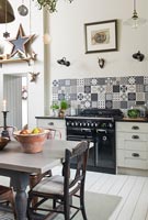 Modern kitchen-diner with range cooker and patterned tile splash back
