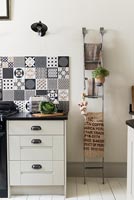 Modern kitchen with range cooker and patterned tile splash back