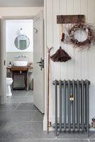 Wall mounted hooks in classic hallway with Christmas wreath 