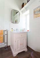Pink sink unit in modern bathroom 