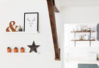 Wooden beam and shelves of ornaments and pictures 