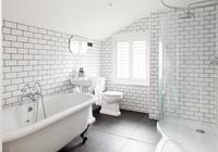 Black and white bathroom with brick style tiling 