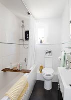Small white bathroom with black floor 