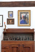 Collection of miniature statues of liberty in wooden cabinet 