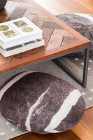 Detail of wooden coffee table and floor cushion 