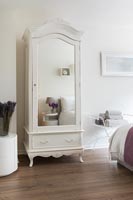 Mirrored vintage wardrobe in modern bedroom 