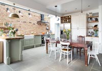Large modern kitchen diner with exposed brick wall 