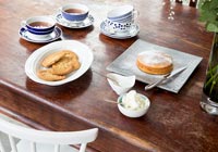 Tea and cake on wooden dining table 