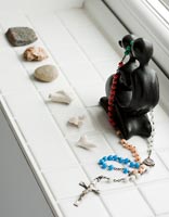 Black ornament with jewellery and collection of stones 