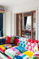 Colourful eclectic living room with internal folding doors to dining room 