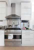 White kitchen with stainless steel appliances and worktops 