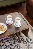 Tea and biscuits on vintage drop leaf coffee table 