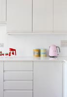 Colourful retro items on modern white kitchen worktop 