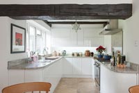 Modern kitchen with low ceilings and exposed wooden beams 