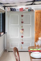 Heart decorations on large cabinet in dining room at Christmas