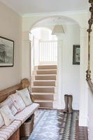 Tiled floor and bench seat in country hallway 