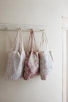 Floral bags on wall mounted hooks 