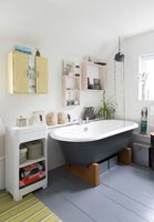 Modern bathroom with grey bath and matching painted floor 