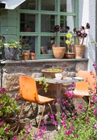 Tiny table and chairs in cottage garden 