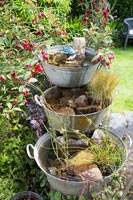 Homemade water feature made with vintage tin bowls 