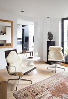 Sheepskin rugs on leather chairs 