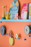 Colourful display of items on shelf and wall mounted button decorations
