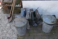 Wellington boots and old galvanized metal bins 