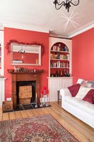 Classic modern living room with red painted walls and Christmas decorations 
