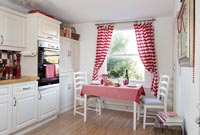 Small table in modern country style red and white kitchen 