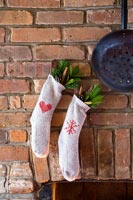 Christmas socks used as stockings decorations on brick fireplace 