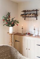 Wine rack and glasses above country sideboard at Christmas