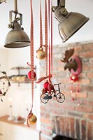 Christmas decorations hanging from pendant lights 