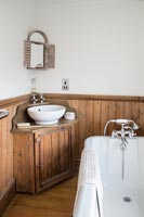 Corner sink unit in wooden country bathroom 