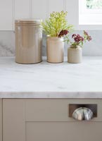 Earthenware pots on marble worktop in modern country style kitchen 