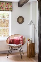 Circular wicker chair and wooden block side table 