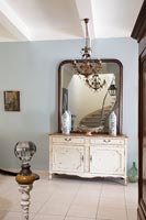 Sideboard and mirror in country hallway 